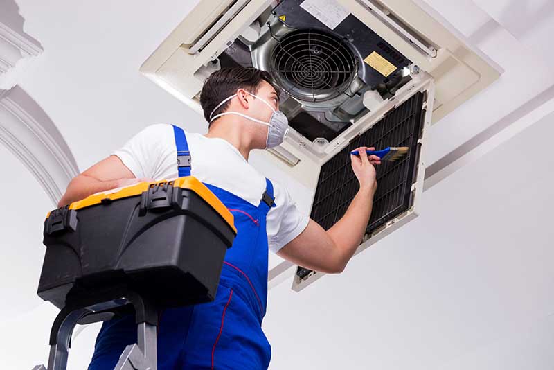 technician cleaning an air duct