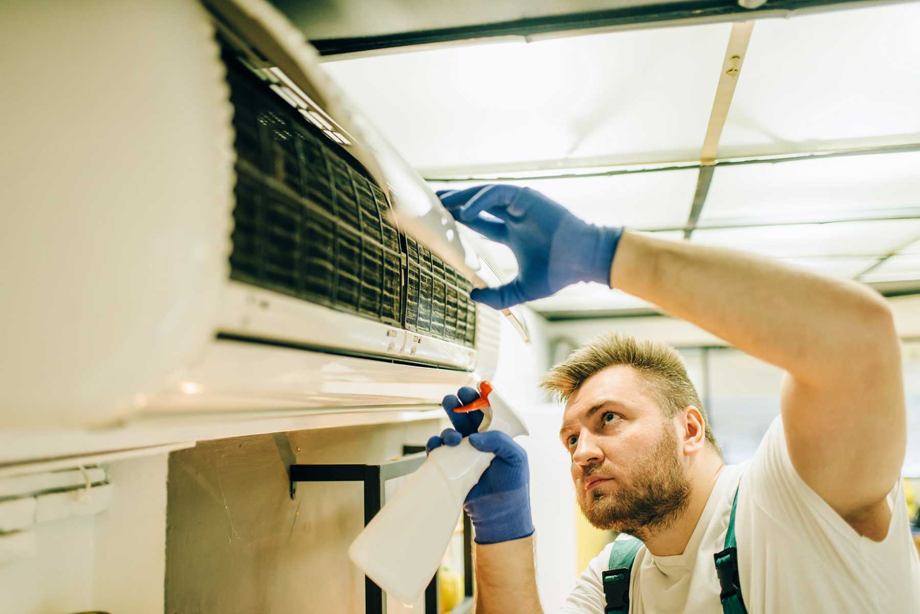 technician repairing HVAC system background