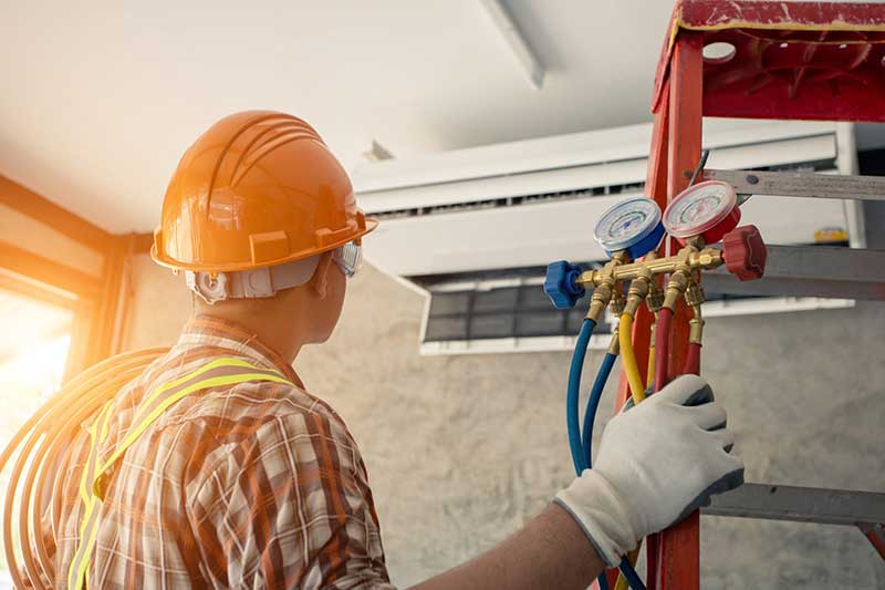 technician tuning a ductless air system